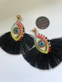 Beautiful Tassel Evil Eye Earrings.  Pick from two colors. Vibrant red or Black.  Can be perfect as a gift or for personal fashion use. Colorful Evil Eye, Frida Kahlo Earrings, Red Or Black, Evil Eye Earrings, Eye Earrings, Vibrant Red, Evil Eye, Jewelry Earrings Dangle, Etsy Earrings