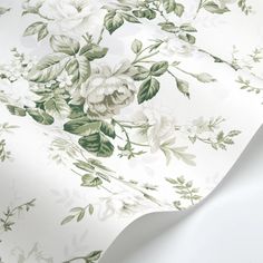 a white and green flowered wallpaper with lots of flowers on it's side