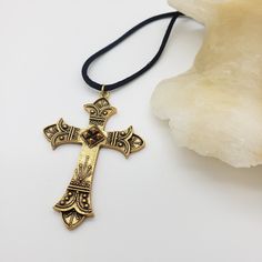 This pendant is a reproduction of a 19th century cross derived from crosses worn by soldiers in the Crusades of the 11th-13th centuries. This beautiful necklace has a nice weight and is comfortable to wear. Materials: Pewter with antique gold plating and a 28" cotton cord Pendant size: 1.75" wide and 2.5 inches long Made in USA Sales from this jewelry go to support The Art Institute of Chicago. Bronze Cross Bohemian Necklace, Bronze Bohemian Cross Necklace, Bohemian Bronze Cross Necklace, Gold Cross Jewelry With Large Pendant, Brass Cross Necklace As A Gift, Brass Cross Necklace For Gift, Bohemian Brass Cross Jewelry, Adjustable Brass Cross Jewelry, Antique Gold Jewelry For Blessing