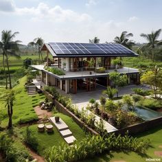 an aerial view of a house with solar panels on the roof and landscaping around it