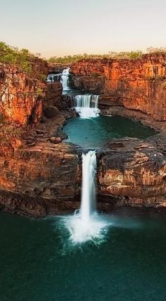 an image of a waterfall in the middle of a river with water coming out of it