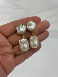 Gorgoeus baroque pearl earrings!  The actual pair on the listing has been sold. This is custom ordered.  This handmade Baroque Pearl earrings is classic and elegant.  The Baroque or flameball cultured freshwater dangling pearls are large 14mm to 15mm x 20mm to 21mm,  white, lustrous, AAA quality, attached to a gold filled bail/peg.  The ear finding is a beautiful 22k gold plated freshwater baroque Pearl, bezeled, brass body. Comes with large ear nuts.    Just simply gorgeous, great for weddings, Formal Baroque Pearl Chain Earrings, Pearl Drop Baroque Pearl Earrings For Anniversary, Elegant Baroque Pearl Earrings In Pear Shape, Elegant Baroque Pearl Earrings In Pearl White, Elegant Baroque Pearl White Pearl Earrings, Anniversary Baroque Pearl Drop Earrings, Bridal Earrings With Baroque Pearl Charm As Gift, Party Pearl Earrings With Baroque Pearl Pendant, Baroque Pearl Earrings With Pearl Pendant For Party