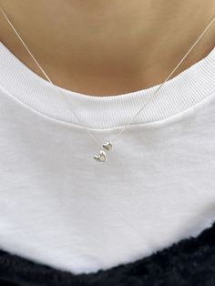 Editor's NotesInvisible collage presents a cute double-heart pendant necklace. It adds a lovely touch to your overall appearance. - Double-heart pendants- Box chain- Smooth glossy surface- Sleek silhouette- Made of silver 925- Lovely and casual mood Measurements(in.)One Size- Size: 15.35 ~ 16.54 in. (L) Composition & Care- Material: Sterling Silver, Cubic- Plated products may discolor over time due to their nature.- Please be careful that discoloration may proceed fa Cheap Silver Charm Necklace For Women, Affordable Silver Double Heart Necklace, Luxury Dainty Double Heart Necklace, Minimalist Heart Necklace, Affordable Classic Silver Charm Necklaces, Pretty Dainty Necklaces, Cheap White Hypoallergenic Charm Necklaces, Delicate Pendant Necklace, Necklaces From Boyfriend