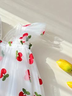 Frolic through the day in this delightful cherry-embellished flower girl dress. The airy tulle skirt is sprinkled with a cheerful pattern of red fruit and greenery, invoking the playful spirit of a sunny orchard. With its flutter sleeves and an oversized back bow, this dress is perfect for a little one who loves to play dress-up for real-life special occasions. US Length Bust size 9-12M 18.5 20.1 1-2Y 19.3 20.9 3-4Y 20.5 22.1 4-5Y 21.7 23.2 5-6Y 22.9 24.0 Cute Tulle Dress For Spring, Summer Floral Print Tulle Dresses, Whimsical Summer Dress With Tulle Skirt, Whimsical Summer Tulle Dress, Summer Tulle Dress With Floral Applique, Playful Floral Embroidery Dress For Spring, Sleeveless Tulle Princess Dress For Spring, Playful Floral Embroidery Spring Dress, White Tulle Dress With Floral Print