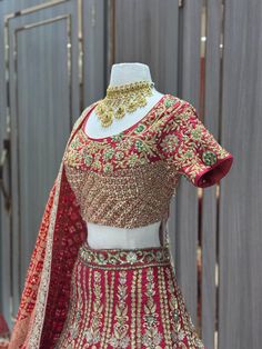 Unleash your inner daring with our JUNE MADNESS ONLINE EXCLUSIVE - 019! This bold and beautiful red peacock bridal lehenga with bandhani dupatta is the perfect addition to a Rajasthani look. Stand out from the crowd and embrace the adventurous spirit within you. A limited quantity is available, so don't wait! Fabric: Raw Silk! WASH CARE INSTRUCTIONS - Please Dry clean only when it is applicable. Ready to Ship! Red Anarkali Sharara For Reception, Designer Red Sharara In Chinon, Red Embellished Sharara For Navratri, Designer Red Sharara With Zari Work, Red Embellished Saree For Reception, Red Embellished Floor-length Saree, Red Semi-stitched Anarkali Set For Reception, Red Anarkali Set For Reception With Traditional Drape, Red Embellished Saree For Navratri