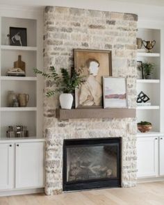 a living room filled with furniture and a fire place in front of a brick wall