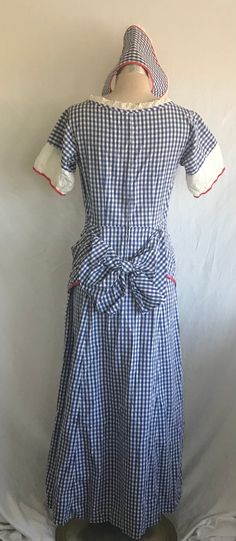 "1880's by way of the 1940's blue and white cotton gingham peplum and back bow bustle dress. Perhaps a costume for a play at one time, but cute as can be! Dress has short, puff sleeves with a red cotton trim and white eyelet contrast. Dress features a nice scoop neckline trimmed with white cotton lace and red twill tape. There's is a metal zipper at the center back of the dress (typical of that time). There's also a matching \"faux bonnet\" made out of the same fabrics and trims. Sleeve openings Contrast Dress, Bustle Dress, Victorian Revival, Dolman Sleeve Sweater, Puff Sleeve Dress, White Eyelet, Puffed Sleeves Dress, Pin Up Style, Metal Zipper