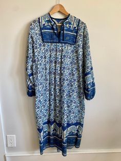 "Vintage 1970s Indian cotton block print bohemian maxi dress / peasant dress / kaftan. Shades of blue (cobalt, turquoise and navy) with black & gold accents on a white background. No tag or size but could fit a size XS with room up to a size Medium depending on one's body. Dress measures 20\" across the chest from armpit to armpit and 45\" long. Pleated / bib front with small ties from v-neckline. Generously cut from shoulder to bottom hem. Billowy sleeves with elastic cuffs. A stunning, one of Blue Printed Long Maxi Dress, Bohemian Long Sleeve Flowy Peasant Dress, Vintage Blue Maxi Dress For Vacation, Flowy Long Sleeve Bohemian Peasant Dress, Blue Long Bohemian Dress, Bohemian Long Sleeve Maxi Dress With Vintage Print, Long Sleeve Peasant Dress With Boho Print, Long Sleeve Bohemian Maxi Dress With Vintage Print, Blue Bohemian Maxi Dress