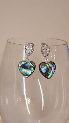 Abalone  hearts with teardrop CZ accented silver ear posts. Approximately 1.5 inches long. Silver Heart-shaped Pearl Drop Jewelry, Silver Heart Earrings With Pearl Drop For Gift, Silver Heart Earrings With Pearl Drop As Gift, Silver Dangle Heart Earrings With Pearl Drop, Silver Heart Crystal Earrings For Wedding, Silver Heart Earrings With Pearl Drop, Silver Dangle Heart Earrings, Silver Dangle Heart Earrings For Party, Valentine's Day Teardrop Earrings