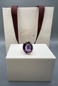 This beautiful ring from Canova Jewelry features a stunning oval-shaped amethyst stone, set in 925 sterling silver. The amethyst is a natural creation, with a purple color and excellent cut grade. The ring is handmade, with a ring size of 7.5. The amethyst is surrounded by blue topaz stones, with a prong setting style. The ring is plated with rhodium and gold, giving it a beautiful and unique finish. This ring is perfect for various occasions, including anniversaries, birthdays, Christmas, graduation, Valentine's Day, and weddings. The vintage and handmade design of this ring adds to its beauty and makes it a perfect gift for someone special. Blue Topaz Stone, Beautiful Ring, Amethyst Stone, Amethyst Ring, Handmade Design, Rings Statement, Purple Color, Prong Setting, Blue Topaz