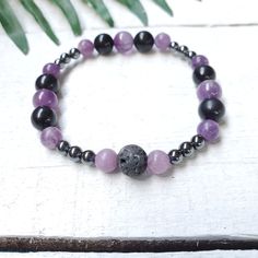 Amethyst, Lepidolite, Shungite and Hematite Bracelet.  I made this bracelet with the intention to help open you up to higher realms, intuition and dream recall while also being grounded and  protected.  Amethyst enhances your intuition and helps you to trust yourself.  Lepidolite helps you to be open to understanding your dreams. Helps you to be able to calm down and be open. Shungite helps us to detox our life and know what is most important in our lives at the moment and what knowledge is comi Black Amethyst 8mm Bead Bracelets, Black Amethyst Bracelet With 8mm Beads, Black Amethyst Bracelets With 8mm Beads, Black Amethyst Beaded Bracelets Spiritual, Spiritual Black Amethyst Beaded Bracelets, Black Amethyst Gemstone Bracelet, Black Amethyst Gemstone Bracelets, Black Amethyst Bracelet As Gift, Black Amethyst Crystal Bracelet In Spiritual Style