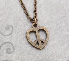 "This listing is for a peace sign heart charm necklace. You'll be able to choose your chain length and style at checkout by using the \"Chain Length/Style\" drop-down menu. Keyrings, bangle bracelets, ball chains, and black/brown leather and suede cord are also available. **Please see the second photo for scale! If you're on the mobile site, just swipe to the side. :) - - - - - - - Sign up for our newsletter to receive coupons and updates on new items! Follow the link: ♦ ♦ ♦ http://eepurl.com/cG Peace Sign Necklace, Heart Charm Necklace, Sign Necklace, Suede Cord, Hippie Jewelry, Necklace Boho, Peace Sign, Ball Chain, Boho Necklace