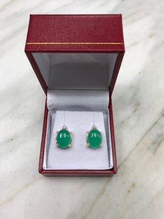 Featured here is a magnificent set of 8.50 total carat weight, cabochon-cut emerald & diamond studs in fine 14K yellow gold. Displayed are medium-green emeralds with very good transparency, accented by brilliant round diamonds in a simple four-prong gold mount, allowing for the emerald to be shown in full view. The earth mined, green emeralds have a desirable lush green color with excellent qualities. These earrings are ideal for everyday use and are the perfect accessory to any outfit. Emer Fine Jewelry Cabochon Gemstones For Formal Occasions, Formal Fine Jewelry Cabochon Gemstones, Exquisite Formal Gemstone Cabochons, Elegant White Gold Cabochons For Formal Occasions, Formal Hallmarked Diamond Cabochons, Formal Fine Jewelry Gemstone Cabochons, White Gold Fine Jewelry Cabochons For Anniversary, Fine Jewelry White Gold Cabochons For Anniversary, Green Gemstone Cabochons For Formal Use