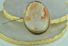 "Vintage 18K Yellow Gold Shell Cameo Pin Pendant, finely carved portrait deco style looking right, wispy hair ear pendants and pearl necklace all finely crafted, shiney background, rope twist frame, 1.75x1.5\" overall, blush to head band and bodice, locking clasp, swing bail, Circa 1940, 13.5 grams Stock # BB213L16 This listing contains photographs of the actual item you will receive. Our items are in excellent condition with little or no signs of wear and many are one of a kind pre-owned estate Darker Highlights, Gold Coin Ring, Wispy Hair, Rope Twist, Cameo Jewelry, Pin Pendant, Vintage Portraits, Fine Jewelry Designers, Yellow Gold Earring