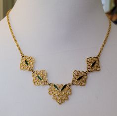 17 inch signed Monet gold tone filigree with a touch of green enamel excellent condition  This is a vintage item and may have some signs of wear.  I will do my best to describe any issues If you are unhappy with your purchase, please let me know and I will do my best to fix it. Victorian Gold Enamel Necklace, Gold Filigree Costume Jewelry Necklace, Vintage Gold Emerald Necklace For Formal Occasions, Ornate Green Necklace With Intricate Design, Ornate Green Necklace For Formal Occasions, Formal Costume Jewelry Necklace With Filigree, Gold Filigree Jewelry With Enamel, Gold Enamel Necklace For Wedding, Vintage Green Filigree Necklace