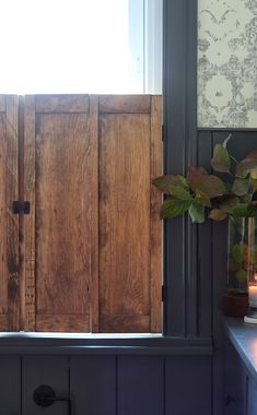 a wooden cabinet sitting next to a window