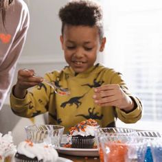 two children eating cupcakes at the table