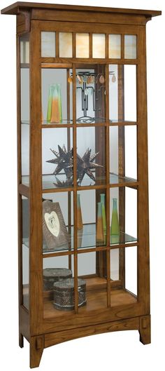 a wooden display case with glass doors on the front and bottom shelves, holding various items