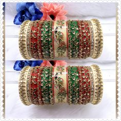 Beautiful Hand Made Traditional Indian Bangles With Kundan Work Hand Work On It. Traditional Hand Work Bangle Chura Set Is Perfect For Wedding Party Wear Or Any Indian Occasion. These Multi-Color Bangles Would Add On In Your Looks. Center Piece Of The Chuda Has Peacock Painting Which Is Making It More Attractive And Making It Real Heavy Rajwari Chuda. Available sizes - 2.4 / 2.6 / 2.8 Why is Chura worn? Popular especially among Punjabi brides-to-be, the wedding Chura signifies the beginning of their wedded life ahead. Although now the Chura has become quite a fashion statement among women, it is traditionally considered to be an important and auspicious Shringar of a newly married bride. Why do Indian brides wear red bangles after marriage? This piece of jewellery signifies good fortune an Festive Traditional Wear With Stone Work For Festivals, Heavy Red Traditional Wear For Festive Occasions, Red Kundan Bangle With Zari Work, Traditional Bridal Sets With Gota Work For Festive Season, Traditional Bridal Sets With Gota Work For Festivals, Multicolor Tilla Lehenga For Wedding, Multicolor Wedding Lehenga With Tilla, Multicolor Lehenga With Stone Work For Wedding, Traditional Heavy Lehenga For Festivals