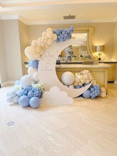 a balloon arch decorated with balloons in the shape of an moon