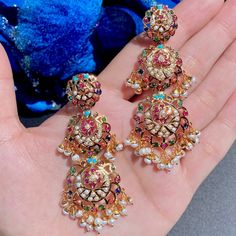 These jadau danglers feature beautifully crafted Navaratna stones, elevating any outfit from ordinary to exquisite. Step into a world of luxury and adorn yourself with these stunning earrings that represent timeless beauty and sophistication. Light to wear, the earrings close with a bombay screw and are approximately 3 inches tall. Luxury Gold Danglers, Luxury Danglers, Designer Chandbali Earrings With Latkans, Designer Tilla Earrings For Diwali, Bollywood Style Earrings With Latkans For Designer Wear, Designer Wear Festival Chandbalis, Traditional Designer Earrings For Diwali, Festive Designer Earrings With Latkans, Traditional Festive Designer Earrings