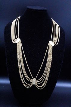 "DESCRIPTION: This is a stunning vintage necklace/belt from the 80s, perfect for adding a touch of glamour to any outfit. The piece is crafted entirely of textured gold plate and designed in a multi-chain manner. It is a festoon piece, with the chains cascading down in a beautiful and elegant way. This necklace/belt is in mint condition and has a hook clasp for secure closure. Measuring 35\" long by 1\" wide, it can be worn as a necklace or a belt, making it a versatile addition to your jewelry Glamorous Gold Metal Necklace, Glamorous Gold Choker For Evening, Gold Chain Jewelry For Evening, Elegant Gold Chain Belt With Double Chain, Elegant Gold Double Chain Belt, Gold Costume Jewelry Choker For Evening, Glamorous Gold Necklace For Evening, Party Double Chain Gold-tone Necklaces, Gold-tone Double Chain Necklace For Party