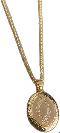 a gold necklace with a medallion on the front and back of it's chain