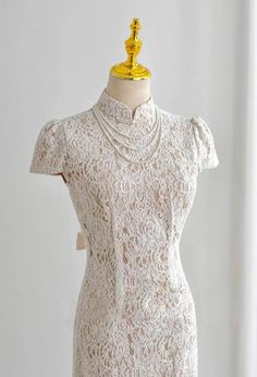 a white dress on a mannequin stand