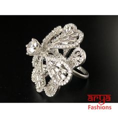 Elegant Cubic Zironia Flower Silver Ring Features: Adjustable Ring to match any finger size Made in Brass with Rhodium finish Lightweight Jewelry Width: 1 Inch Very high quality Cubic Zirconia stones. Suitable for any occasion and traditional or Modern attire Ready to ship and available for local pickup from 23059. Please message us for more details Free shipping on orders above $75 within USA. Elegant White Butterfly Ring For Wedding, Wedding Butterfly Ring In Cubic Zirconia, Elegant Silver Butterfly Ring For Wedding, Elegant Silver Butterfly Wedding Ring, Silver Cubic Zirconia Flower Ring, Silver Cubic Zirconia Rings With Stone Setting, Cubic Zirconia Butterfly Ring For Wedding, Silver Flower Shaped Cubic Zirconia Ring, Silver Flower Ring With Cubic Zirconia