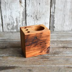 a small wooden box sitting on top of a wooden table