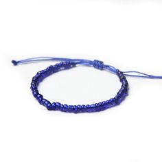 a blue beaded bracelet on a white background