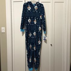 Adult Onesie/Pajamas/Jammies/Romper Frozen - Olaf And Snowflakes. Color Scheme Is A Pixellated Olaf With Dark Blue Background, White Snowflakes, And Gray "Warm Hugs!" Lettering. Cozy Material, Zip-Up With A Hood. Open Hands And Feet. Disney Brand With Original Tag Still Attached. Size M Blue Hooded Sleepwear For Sleepover, Comfy Long Sleeve Blue Sleepwear, Comfy Blue Long Sleeve Sleepwear, Blue Hooded Sleepwear For Pajama Party, Cozy Long Sleeve Blue Onesie, Comfy Blue Sleepwear For Lounging, Cotton Onesie For Winter Sleepover, Cotton Onesie For Sleepover In Winter, Cozy Winter Onesie For Sleep