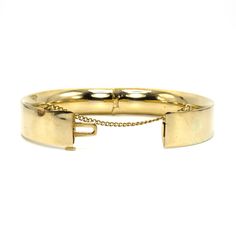 B.A. Ballou was founded in 1868 and continues to produce jewelry today. It is one of the oldest extant manufacturers of American jewelry. This lovely bangle is made of 14 karat yellow gold (the clasp is stamped "14K B.A.B.") and features a safety chain, which ensures the bracelet remains on the wearer should its clasp fail. This clasp is tight as new and the bracelet comes pre-engraved with a trigram that reads "MSM." Metal: 14K Yellow Gold Inside Diameter: 2.5 in. (average size) Vintage Yellow Gold Bangle Stamped 14k, Vintage 14k Stamped Yellow Gold Bangle, Vintage 14k Stamped Gold Bangle Bracelet, Vintage 14k Stamped Round Bangle, Antique 14k Gold Bangle Bracelet, Classic Gold Hinged Bangle, Antique 14k Gold Round Bangle, Antique Round 14k Gold Bangle, Heirloom 14k Gold Round Bracelet