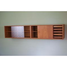 a wall mounted shelf with two compartments and paper towels on it's bottom section