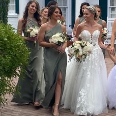 a group of bridesmaids are walking down the street