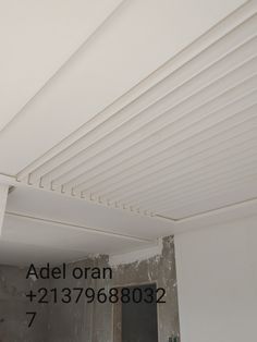 an image of a room being remodeled with white paint on the walls and ceiling beams