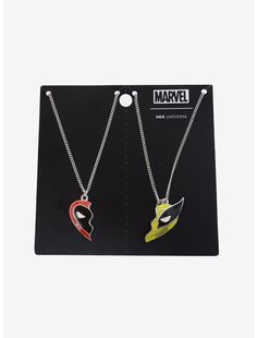 two necklaces that are on display in front of a black card with the words, marvel