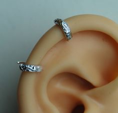 "Textured Pierced Ear-cuff / Helix Cuff Earring / Floral Sterling silver cuff /Small ear cuff / Sterling ear cuff / Scalloped ear cuff / 2 ear cuff so you can wear it anywhere you like.   I can do this shiny or darken it. These are handmade by me and are slightly different sizes. The design is textured with a hint of flowers.  This is a great earring for a man or woman. Measurements- Conch 10mm (3/8\") ID or lobe earrings 1/2\" This listing is for 2 earrings.        Helix 7mm (1/4\") ID   The po White Gold Metal Cartilage Earrings, Silver Clip-on Metal Cartilage Earrings, Adjustable Metal Hypoallergenic Ear Cuff, Adjustable Hypoallergenic Metal Ear Cuff, Adjustable Silver Clip-on Cartilage Earrings, Adjustable Silver Single Clip-on Earring, Elegant Silver Internally Threaded Hoop Earrings, Silver Clip-on Cartilage Earrings As Gift, Silver Clip-on Cartilage Earrings For Gift