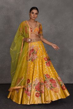 Look your best on wedding occasions like haldi and mehendi in this beautiful yellow Banarasi floral lehenga. It comes with a green net dupatta. Disclaimer: The actual product may vary slightly from the image. These are custom orders, hence expect slight variation in color, placement of the motif or buta. ESTIMATED DELIVERYBecause this is a custom order, it would take about 4-5 weeks from the date of purchase. RETURN POLICYThis product is a custom order and cannot be returned or exchanged. Yellow Dola Silk Anarkali Set With Sheer Dupatta, Yellow Anarkali Set With Sheer Dupatta For Reception, Yellow Dola Silk Choli With Sheer Dupatta, Yellow Choli With Sheer Dupatta In Dola Silk, Yellow Meenakari Dupatta For Festivals, Yellow Semi-stitched Choli With Sheer Dupatta, Yellow Dupatta With Pallu For Reception, Yellow Meenakari Choli For Festivals, Yellow Meenakari Sets For Festive Occasions