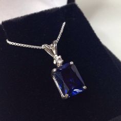 "Beautiful Blue & White Sapphire Pendant Necklace * 4ct Emerald Cut Blue Sapphire measures 10mm x 8mm * Brilliant Cut White Sapphire Accent measures 2.5mm * 4.1cts total gemstone weight * 14k White or Yellow Gold * 18\" Sterling Silver link Chain Included Hallmarked & Gift Ready! Matching Earrings & Ring Also Available! This 4ct Sapphire is Laboratory Grown & is identical to natural in every way, including Chemistry, Composition & Hardness with Excellent Clarity & Color R Elegant Sapphire Necklace With Emerald Cut, Dazzling Sapphire Gemstones For Gift, Dazzling Sapphire Gemstones As Gift, Radiant Cut Lab-created Sapphire Jewelry, Dazzling Sapphire Jewelry For Formal Occasions, Radiant Cut Sapphire Fine Jewelry, Formal Moissanite Gemstone Necklaces, Sapphire Jewelry With Emerald Cut, White Gold Jewelry With Diamond Cut Lab-created Sapphire