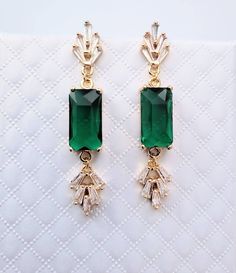 **All orders come with tracked shipping so you can be assured that you will receive your item** PLUS **Free shipping on orders over $35 USD for US customers** High quality champagne gold plated Gatsby style earrings and necklace set with rectangle emerald cubic zirconia stones.  The chain is 1mm thick and 46cm long. It is easily adjustable to make it shorter to your desired length simply by pulling on the chain through the round gold bead. It also has 2 removal options - using the clasp or pulli Art Deco Drop Earrings For Evening, Green Art Deco Drop Earrings, Glamorous Green Jewelry For Formal Occasions, Glamorous Green Jewelry, Vintage Style Emerald Drop Earrings, Art Deco Dangle Jewelry For Weddings, Art Deco Dangle Jewelry For Party, Art Deco Dangle Party Jewelry, Antique Green Jewelry For Evening