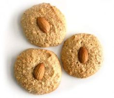 three cookies with almonds on top and the words take ashpaaz com above them