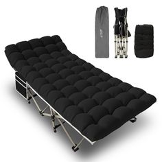 a black futon bed frame with the cover pulled down and two bags next to it