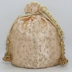 "traditional indian golden zardosi sequin embroider wedding giveaway bag potli | beautiful handmade gifting drawstring purse for woman Package Contents: 1 Size: 10\" x 8\" Designed with the heart, this beautiful Potli or batawa bag are eye catchy and made of premium material. Key Features: Zardosi embroidery art work. This potli is good match with both Indian and western outfits and are superb for wedding and festive parties. This would be best complement to your designer saree, lenhga or any ot Handmade Gold Potli Bag For Party, Festival Reception Potli Bag With Zari Work, Zari Work Potli Bag For Festivals And Reception, Traditional Potli Bag With Dori Work For Reception, Gold Potli Bag With Dori Work For Reception, Bollywood Style Potli Bag With Dori Work For Reception, Traditional Gota Work Bag For Reception, Festive Gold Embroidery Potli Bag, Festive Gold Potli Bag For Reception