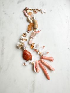 ABOUT THIS PIECE: "Just Peachy" necklace.  Handcrafted, one-of-a-kind, eco-friendly piece entailing: mother of pearl, recycled glass, shells, tiny cotton tassels, Swarovski Crystal, faceted gold pyrite, handmade ceramic + paper beads, wood, bamboo coral, seed bead and 14K gold vermeil hardware. 16" with a 2.5" extender.  Wear this statement necklace anywhere, be it a casual day with a white tee + jeans to a special occasion or on vacation.  I'm happy to custom make a necklace with the colours of Handmade Pink Ocean-inspired Jewelry, Bohemian Coral Jewelry For The Beach, Bohemian Coral Jewelry For Beach, Handmade Ocean-inspired Pink Jewelry, Coral Bohemian Beach Jewelry, Bohemian Orange Necklace For Wedding, Single Strand Shell Necklace, Ideal For Gifts, Shell Single Strand Necklace For Gift, Single Strand Shell Necklace For Gifts