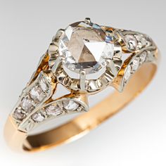 an antique diamond and gold ring with diamonds on it's sidestrands