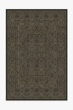 a black rug with an intricate design on the center and sides, in front of a white background