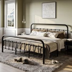 a bed sitting on top of a wooden floor next to a window