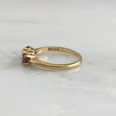 Details: Lovely Mid Century 18K yellow gold diamond and ruby ring, with two rubies and a diamond. Please ask all necessary questions prior to placing an order. Measurements: The size is 5 3/4 US and can be sized for a fee. Condition: The overall all condition of this ring is very good. Heirloom Amethyst Ring With Diamond In Gold, Heirloom Gold Amethyst Ring With Diamond, Classic Three Stone Ruby Ring With Diamonds, Timeless Yellow Gold Amethyst Ring For Anniversary, Hallmarked Yellow Gold Ruby Ring For Wedding, Yellow Gold Hallmarked Ruby Ring For Wedding, Classic Three Stone Round Ruby Ring, Formal Ruby Three Stone Ring With Diamonds, Heirloom Three Stone Ruby And Diamond Ring