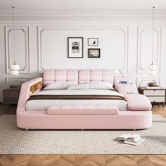 a pink bed sitting in the middle of a living room next to a white wall